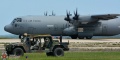 HUMVV's depart while C-130J takes off